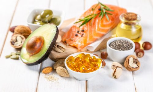 Selection of healthy unsaturated fats, omega 3 - fish, avocado, olives, nuts and seeds
